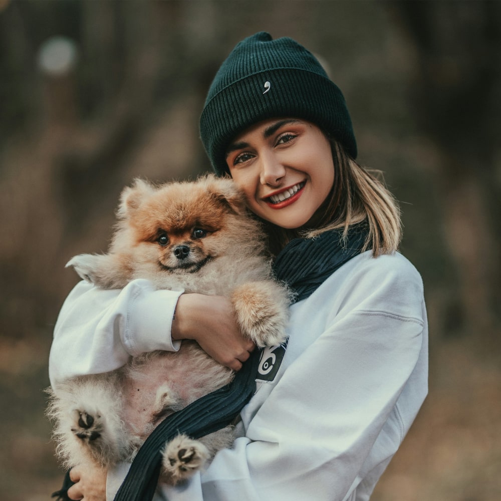 Girl holding her pet dog and hugging him